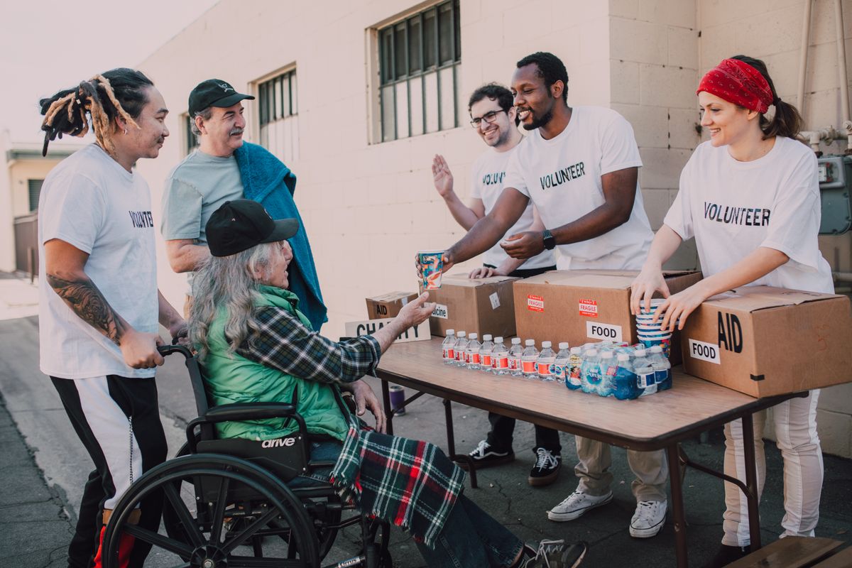Volunteers providing community aid and support outdoors